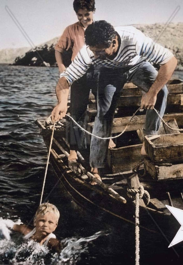 A fisherman (Yves Montand) and his two sons in the late period neorealism drama, The Wide Blue Road (1957)