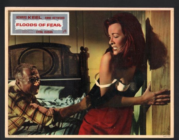 Escaped prisoner Cyril Cusack attacks Anne Heywood in the disaster drama, Floods of Fear (1958)